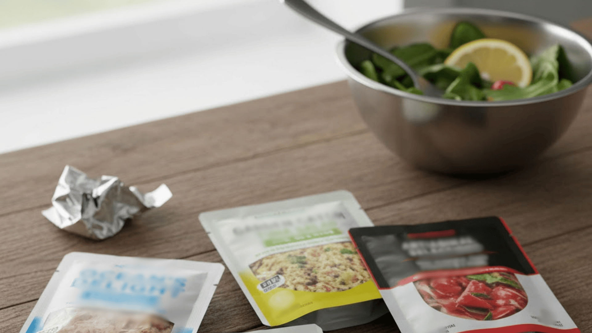 Meal prep ingredients and seasoning packets arranged on kitchen counter