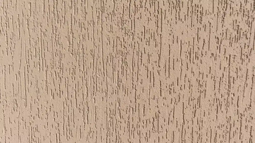 Spray sand drywall texture shows a white grainy plaster surface with small bumps and subtle shadows under even lighting