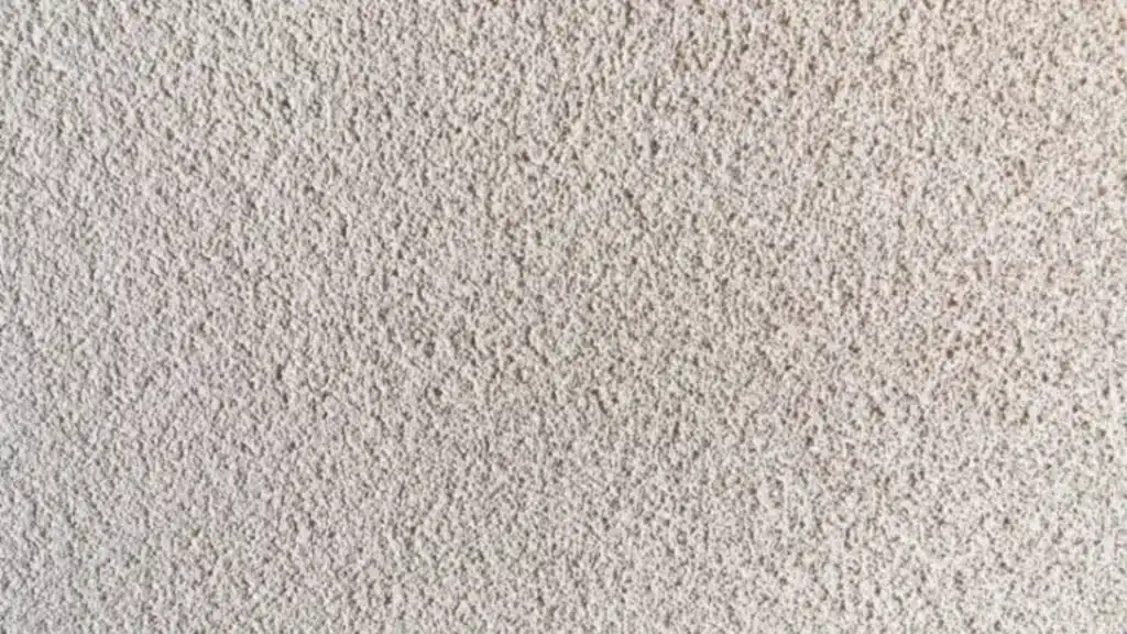 closeup view of white orange peel drywall texture showing bumpy spray patterns and small shadows across the flat surface