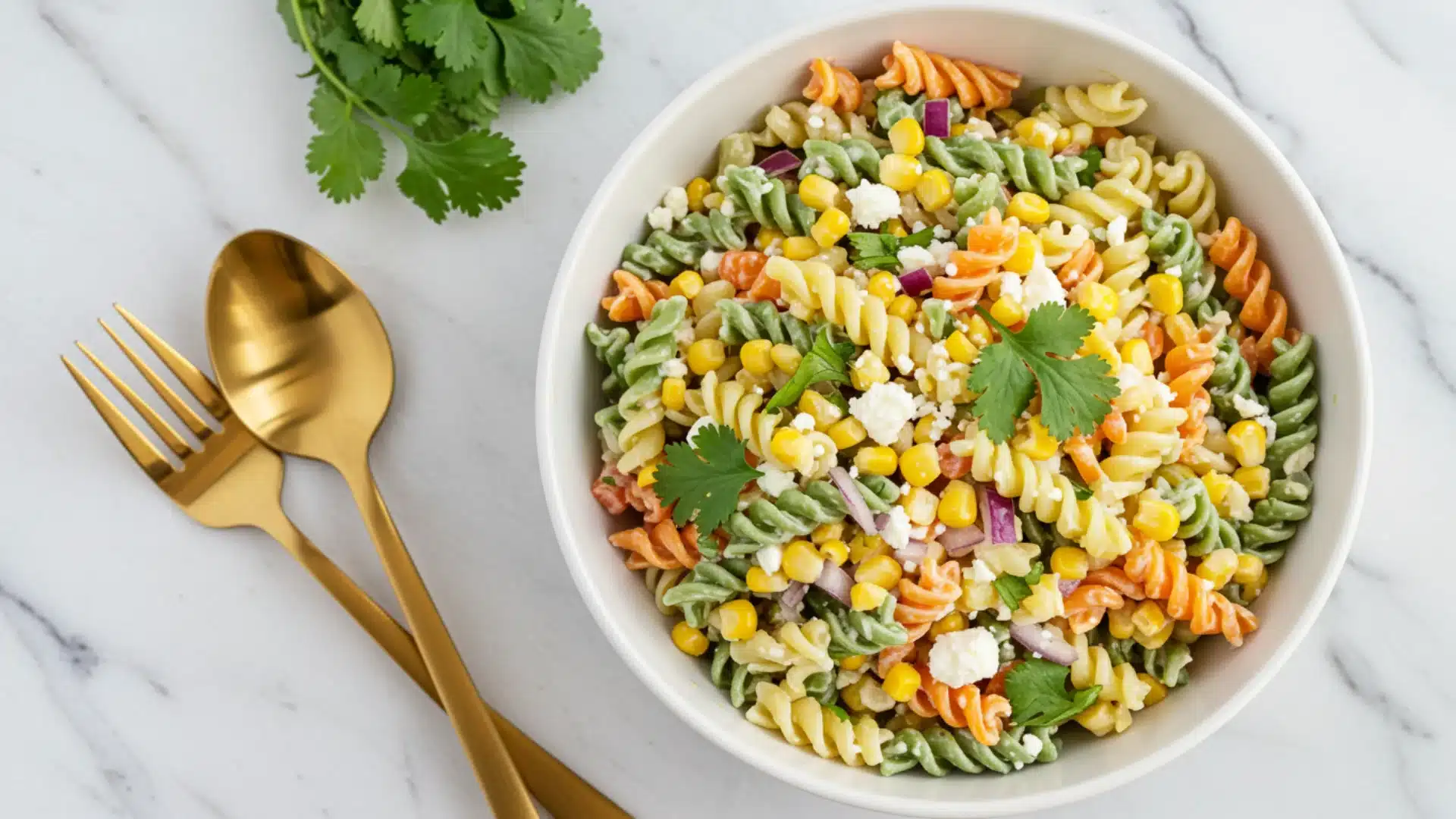 A vibrant corn salad in a white bowl, featuring grilled corn, avocado, red peppers, red onion, and cilantro.